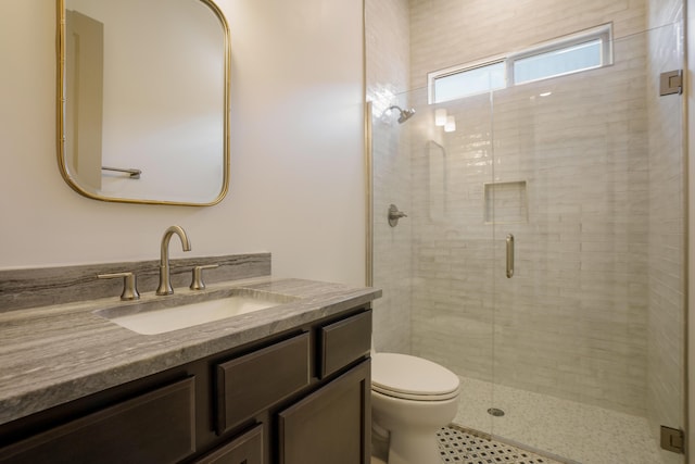 bathroom with vanity, walk in shower, and toilet