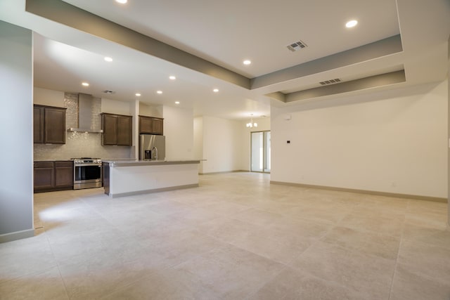 unfurnished living room with a raised ceiling