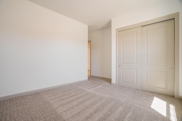 unfurnished bedroom with carpet flooring and a closet