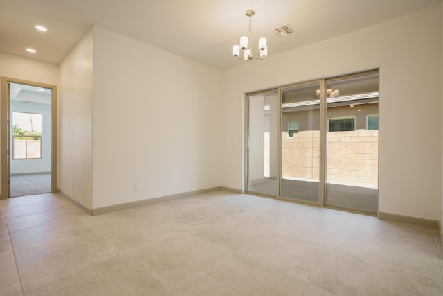 empty room featuring a chandelier