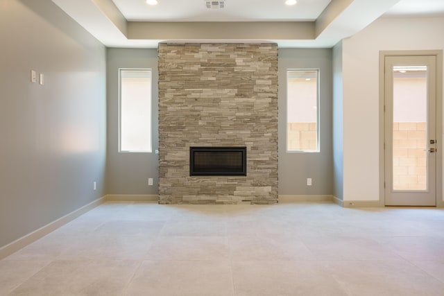 unfurnished living room with light tile patterned floors and a fireplace