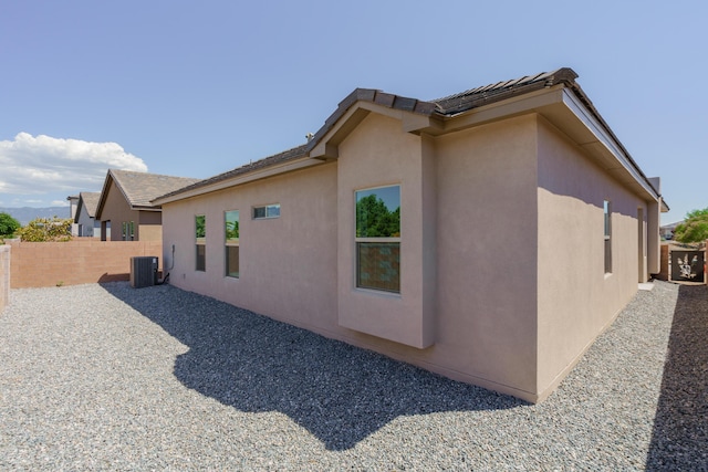 view of side of home featuring central AC