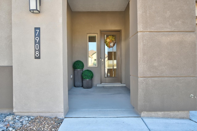 entrance to property featuring stucco siding