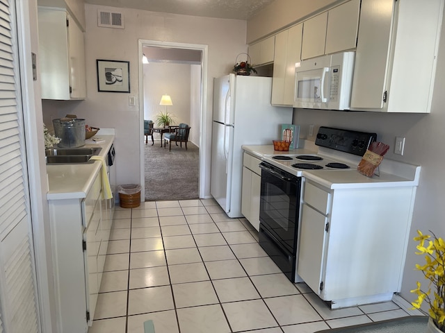 kitchen featuring white cabinetry, light tile patterned floors, white appliances, and sink