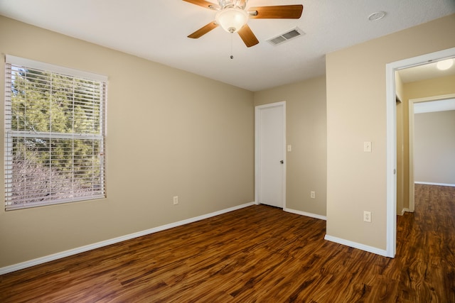 unfurnished bedroom with dark wood-type flooring and ceiling fan