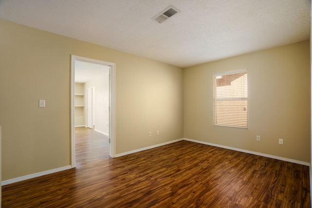 unfurnished room featuring dark hardwood / wood-style flooring