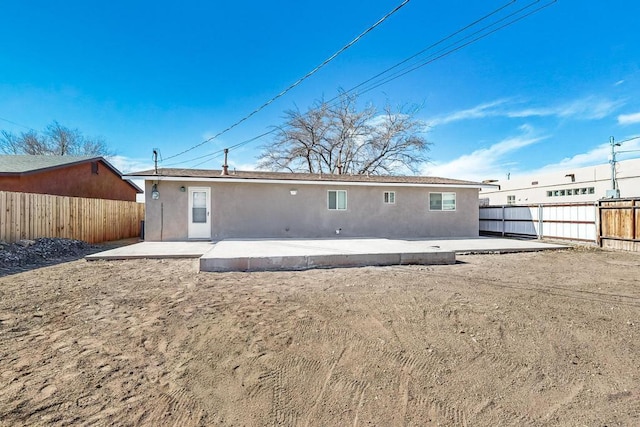 back of property with a patio area, fence, and stucco siding