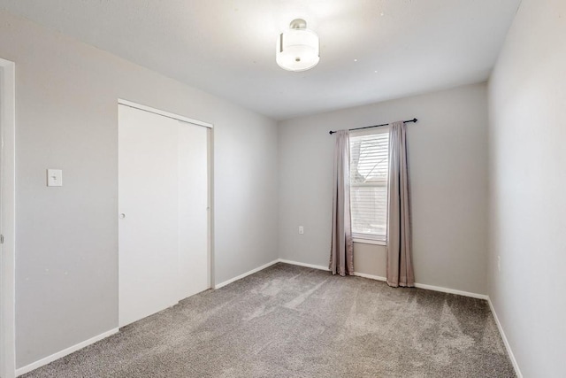 spare room with carpet and baseboards