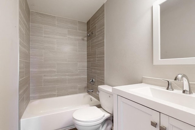 bathroom with washtub / shower combination, vanity, and toilet