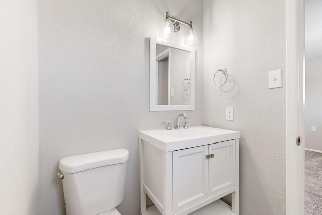 bathroom featuring toilet and vanity