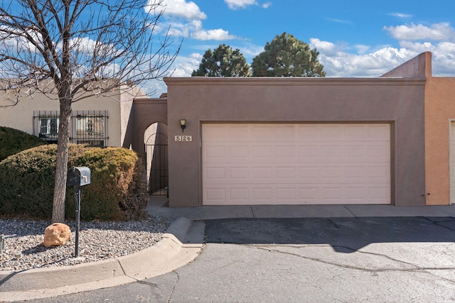 pueblo-style house with a garage