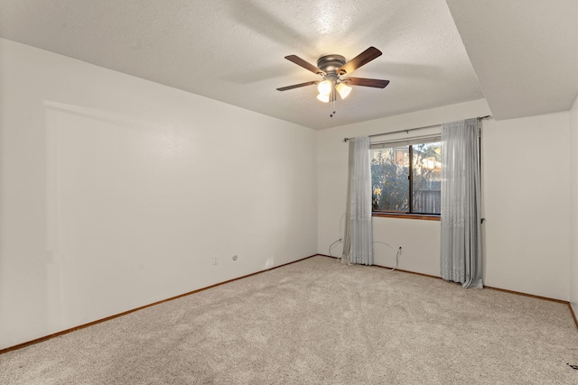 carpeted spare room with ceiling fan and a textured ceiling