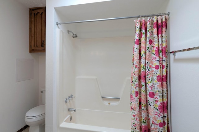 bathroom with shower / bath combination with curtain and toilet