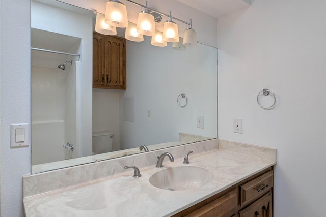 bathroom featuring vanity, a shower, and toilet