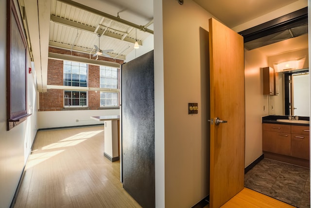 hall featuring sink and light hardwood / wood-style flooring