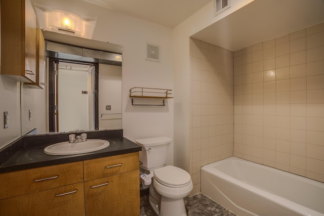 full bathroom featuring vanity, tiled shower / bath, and toilet