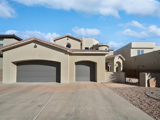 mediterranean / spanish-style house featuring a garage