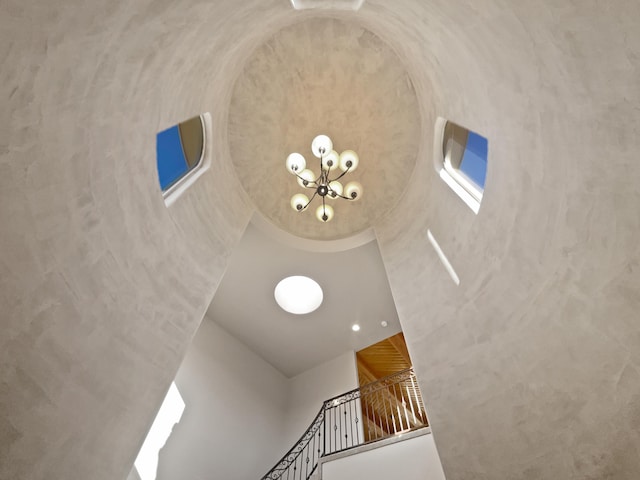 interior details featuring an inviting chandelier