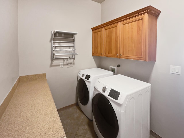 laundry room with independent washer and dryer, tile patterned floors, and cabinets