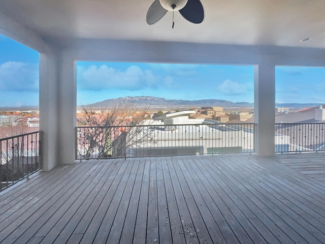 wooden deck featuring ceiling fan and a mountain view