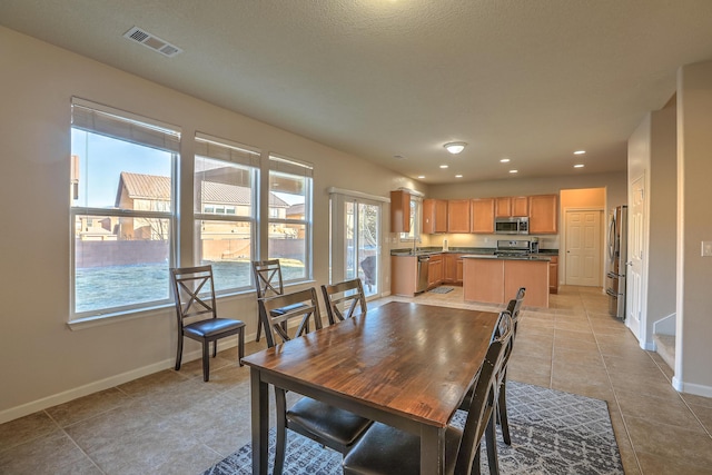 dining area with sink and light tile patterned floors