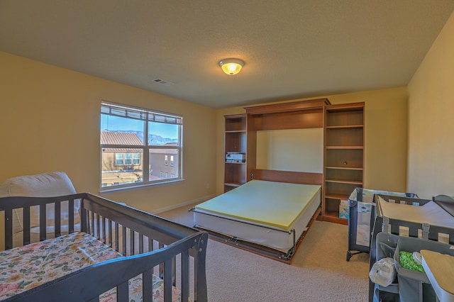 carpeted bedroom featuring a textured ceiling