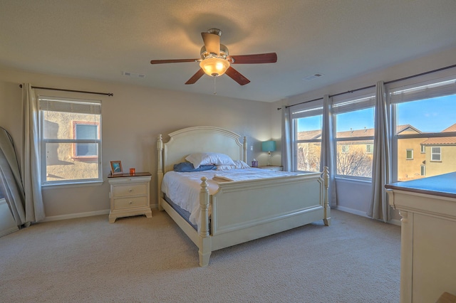 bedroom featuring light carpet and ceiling fan