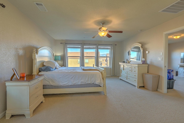 bedroom with ceiling fan and light colored carpet