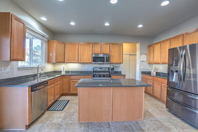 kitchen featuring appliances with stainless steel finishes, sink, a kitchen island, and light tile patterned floors