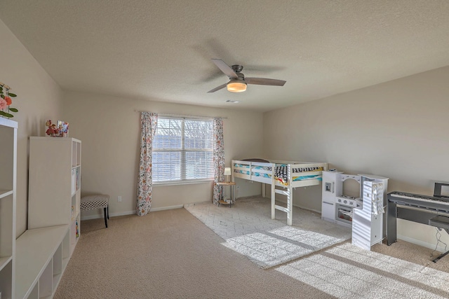 bedroom featuring light carpet, a textured ceiling, and ceiling fan