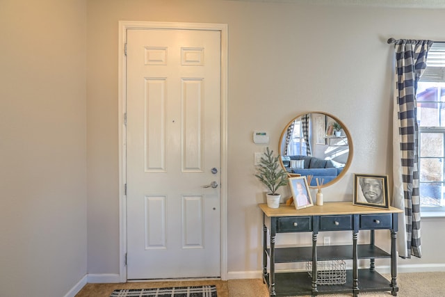 carpeted foyer entrance with plenty of natural light