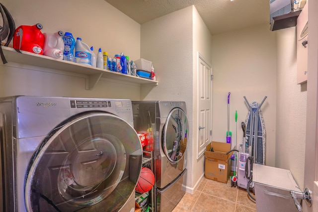 clothes washing area with light tile patterned floors and washing machine and dryer