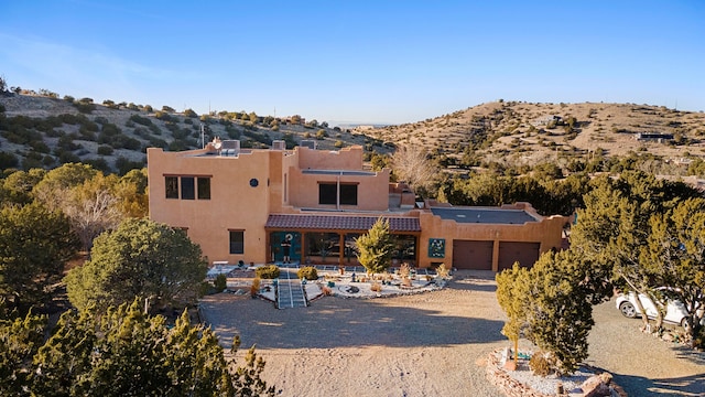 view of front of house featuring a mountain view and a garage