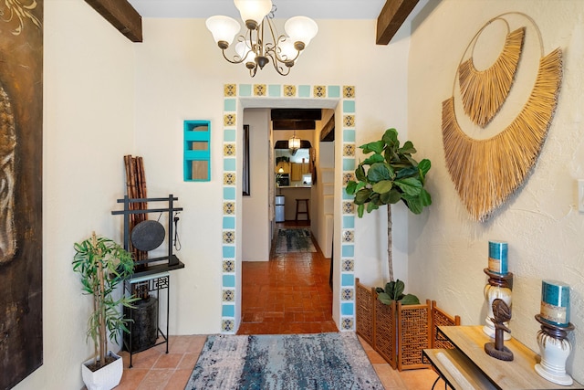 foyer with beamed ceiling and a notable chandelier