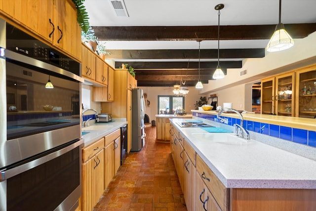 29 Sandia Ln, Placitas, NM 87043 - kitchen featuring decorative light fixtures, beam ceiling, stainless steel appliances, and a sink