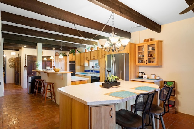 29 Sandia Ln, Placitas, NM 87043 - kitchen featuring a center island, beamed ceiling, brick floor, light countertops, and appliances with stainless steel finishes