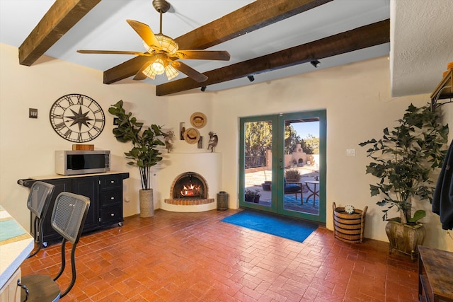 29 Sandia Ln, Placitas, NM 87043 - living area featuring beamed ceiling, brick floor, french doors, and a ceiling fan