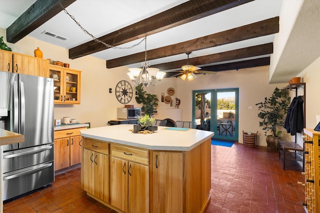 kitchen featuring french doors, a center island, appliances with stainless steel finishes, ceiling fan, and beam ceiling