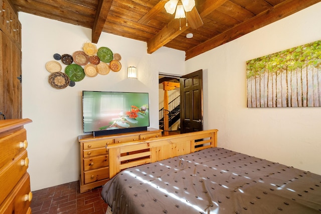 29 Sandia Ln, Placitas, NM 87043 - bedroom featuring beamed ceiling, brick floor, and wood ceiling