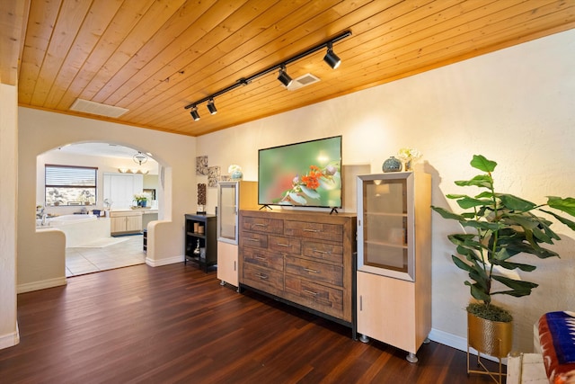 hallway with crown molding, dark hardwood / wood-style floors, and wooden ceiling