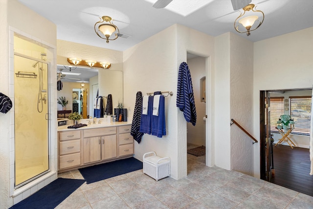 bathroom featuring vanity and a shower with door