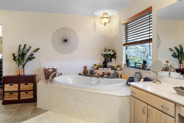 bathroom with tile patterned floors, vanity, and a bath