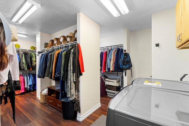 laundry room with dark hardwood / wood-style flooring, separate washer and dryer, cabinets, and a textured ceiling