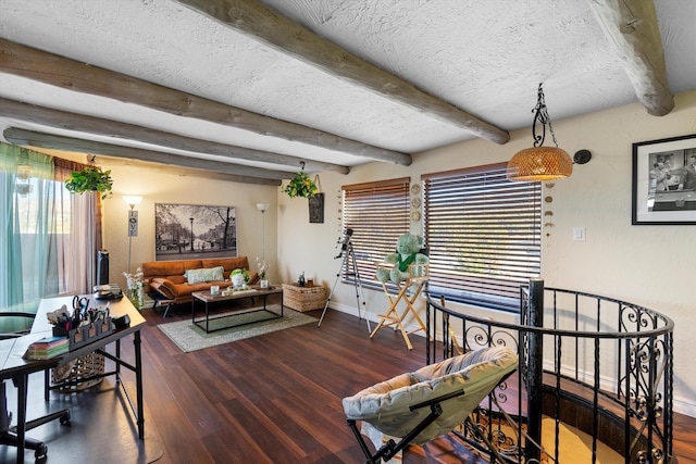 living room featuring hardwood / wood-style flooring, a wealth of natural light, a textured ceiling, and beamed ceiling