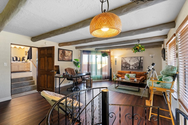 dining room featuring beamed ceiling, dark hardwood / wood-style flooring, and a textured ceiling