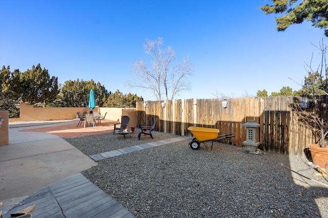 view of yard with a patio and an outdoor fire pit