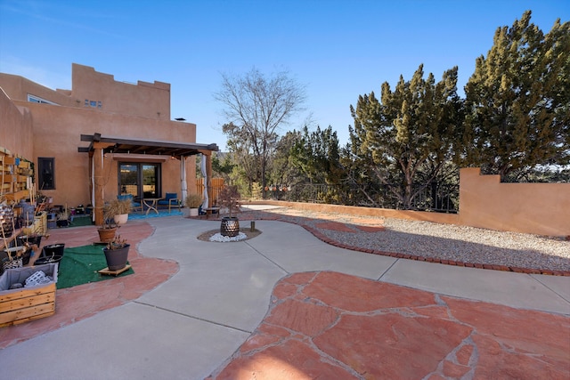 view of patio with a pergola and a fire pit