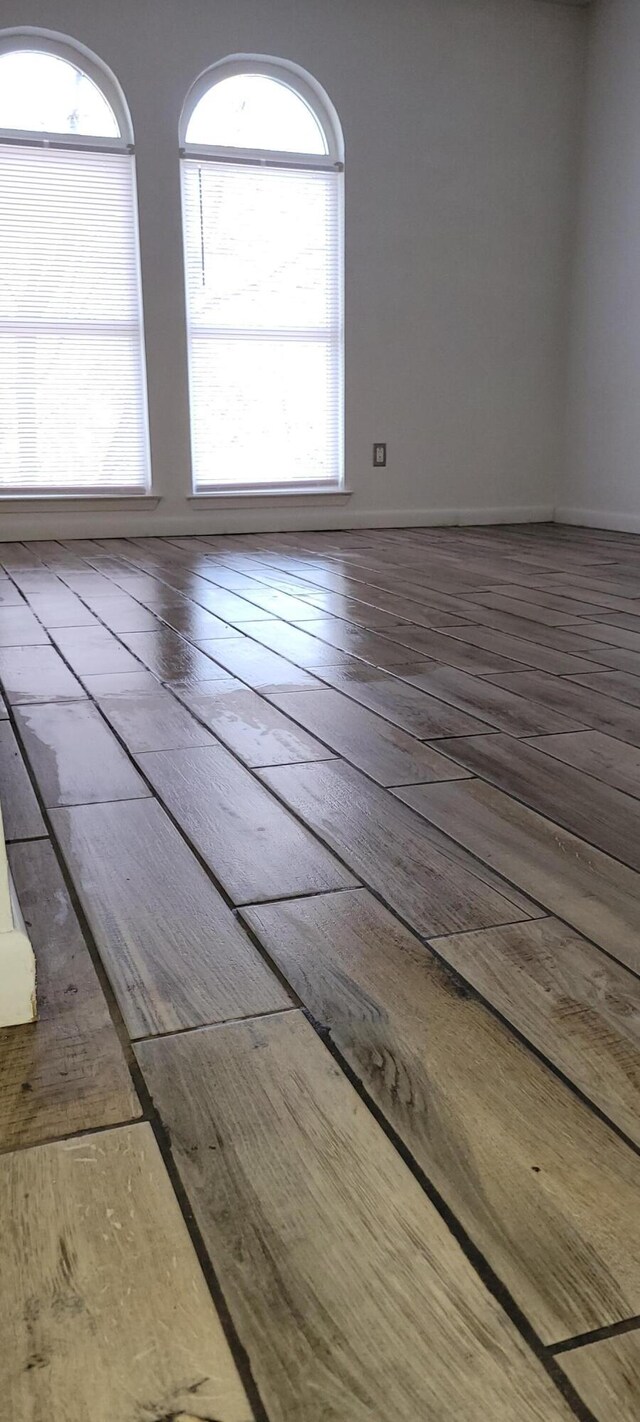 unfurnished room with wood-type flooring