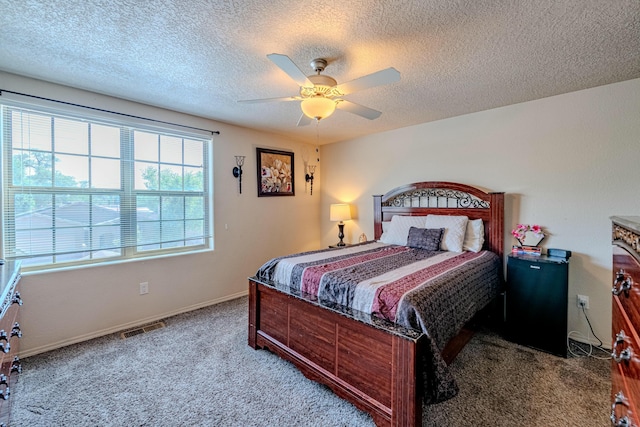 carpeted bedroom with a textured ceiling and ceiling fan