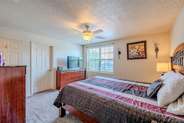 carpeted bedroom with a textured ceiling and ceiling fan